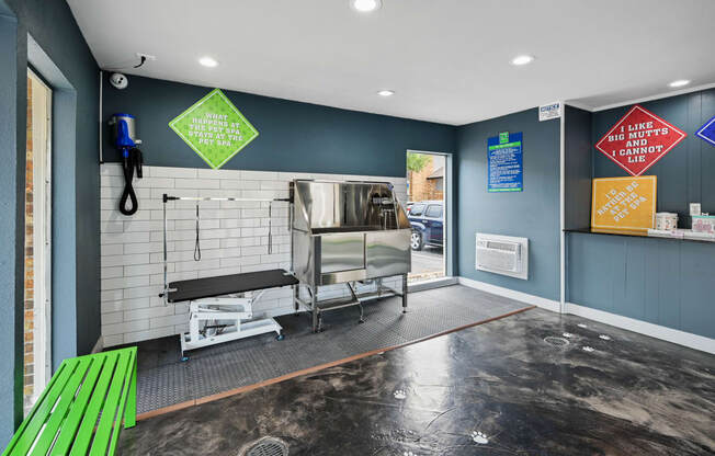 a kitchenette with a bar and a green bench in front of a door