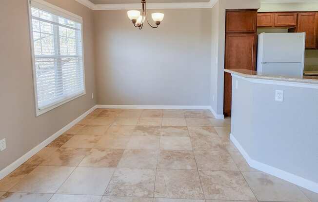 dining and kitchen with travertine in Briarwood floor plan