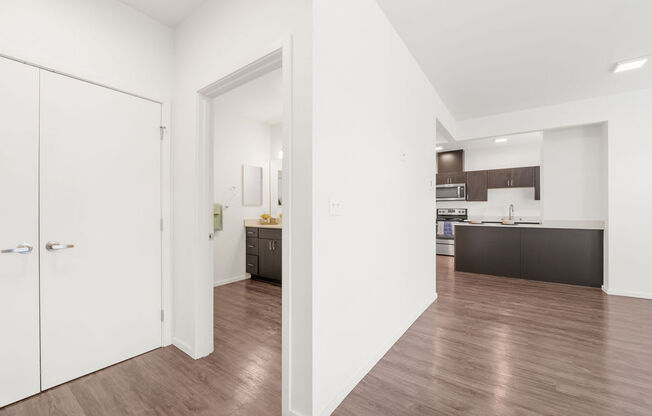 a living room with a medium hardwood floor and white walls