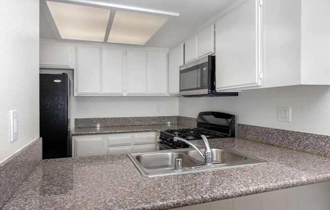 a kitchen with granite counter tops and a sink