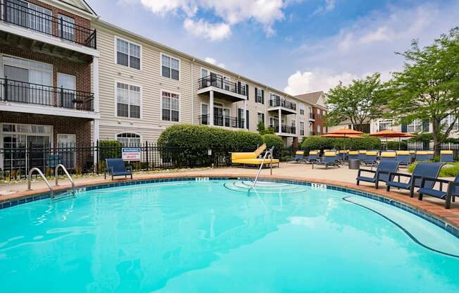 A swimming pool in front of apartment buildings.
