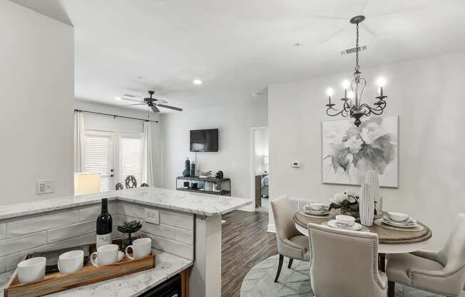 an open kitchen and dining area with a dining table and chairs