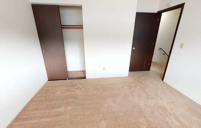 Bedroom with carpet and a sliding door closet