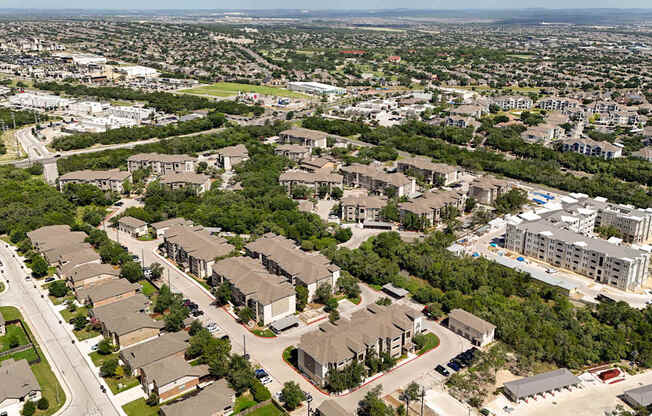 A bird's eye view of a residential area with houses and buildings.