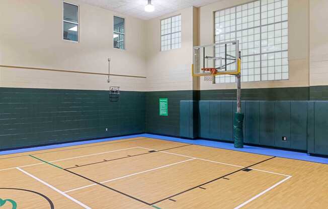 a basketball court in a gym with a basketball hoop