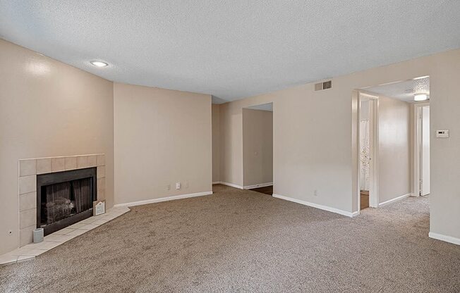 an empty living room with a fireplace