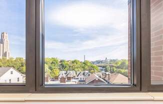 A view of a University of Pittsburgh and Carnegie Mellon University through a window.