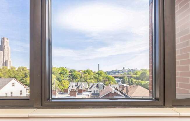 A view of a University of Pittsburgh and Carnegie Mellon University through a window.