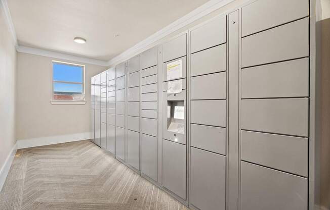 A hallway with a row of lockers on the right side.