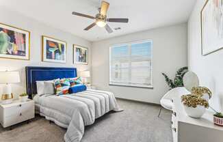 a bedroom with a bed and a ceiling fan