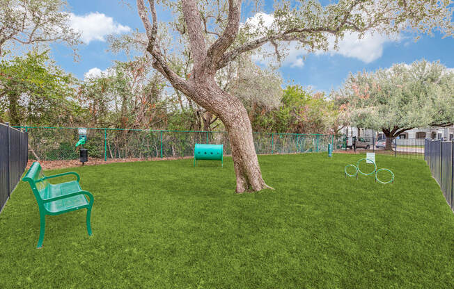 A green plastic chair sits on a green lawn.