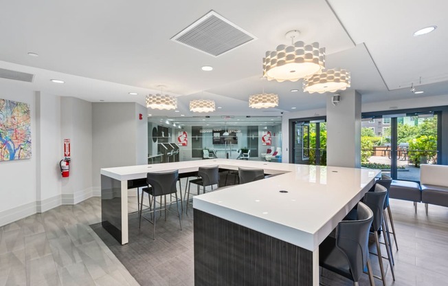 a communal table in a break room with chairs and a counter