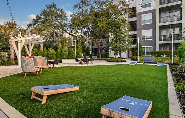 an apartment yard with a ping pong table and chairs