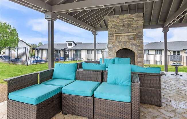 A patio with a couch and a fireplace.
