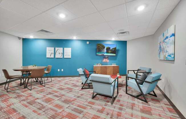 A room with a blue wall and a carpet with a red and beige pattern.