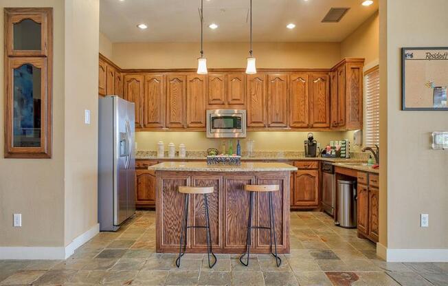 club house bar area with a island and chairs and mini kitchen