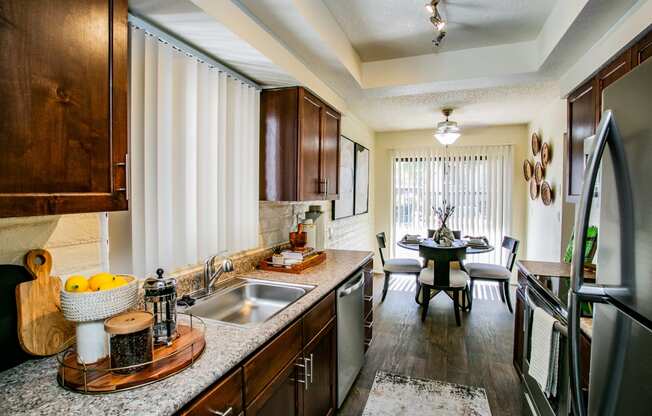 kitchen with stainless steel appliances and granite counter tops and a dining room with a table