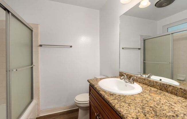 a bathroom with a sink toilet and shower