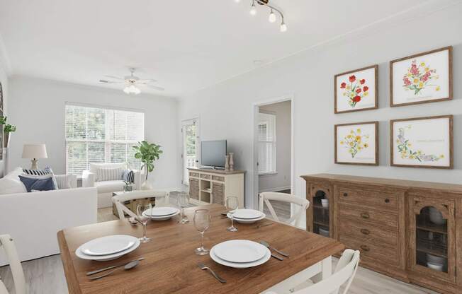 A dining room with a wooden table set for two.