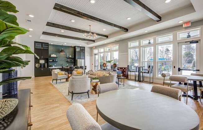 a large living room with couches and chairs and a table