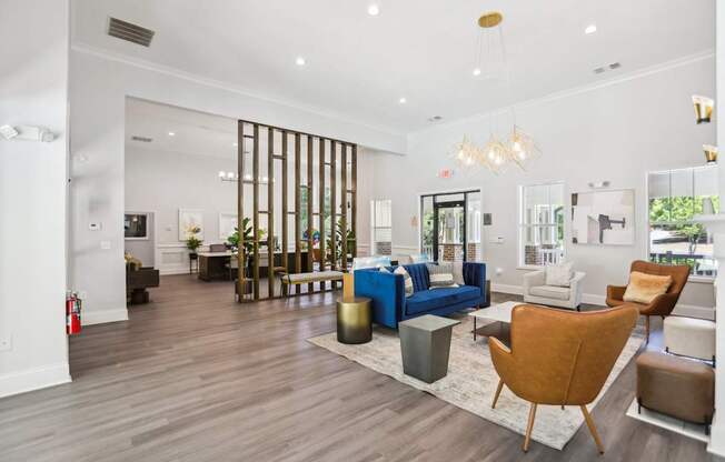 A living room with a blue couch and a brown chair.