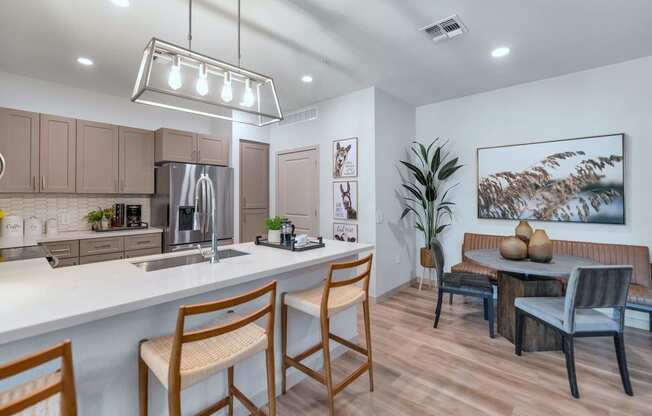 a kitchen and dining room with a table and chairs at Weylyn Luxury Apartments, Laveen, Arizona