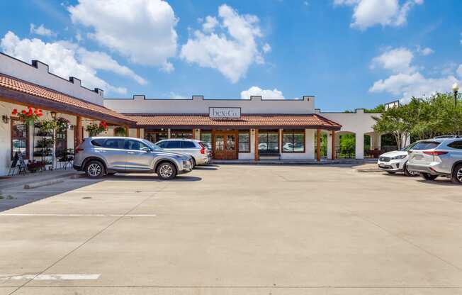 a parking lot in front of a restaurant with cars parked