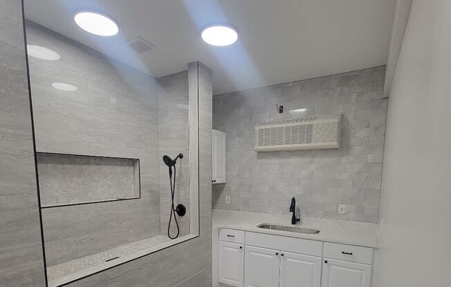 a white bathroom with a sink and a mirror