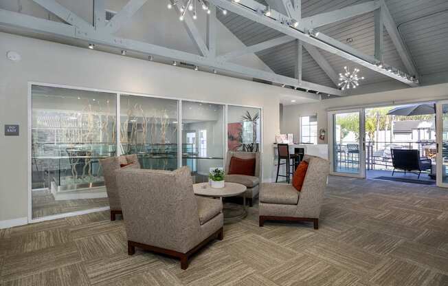 A room with a table and chairs and a glass wall at Verandas Apartments, California
