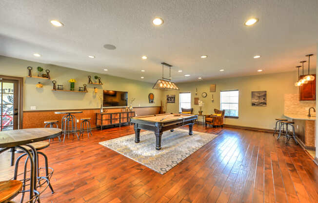 A large open room with wooden floors and a long table.