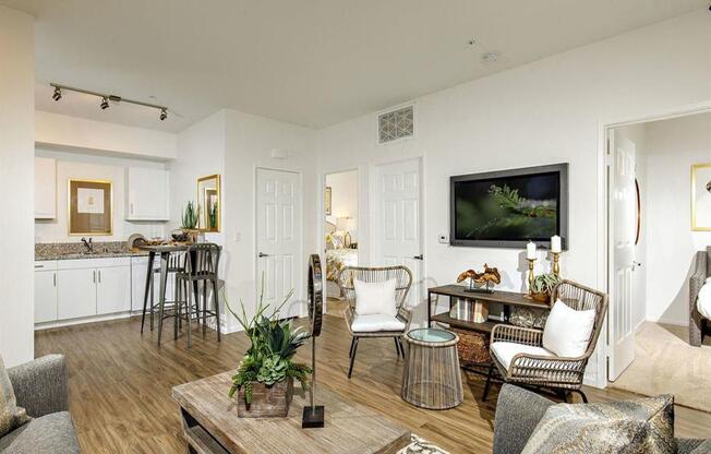 Open floor plan with spacious living room and white kitchen cabinets