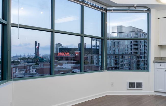 A room with a large window overlooking a cityscape.