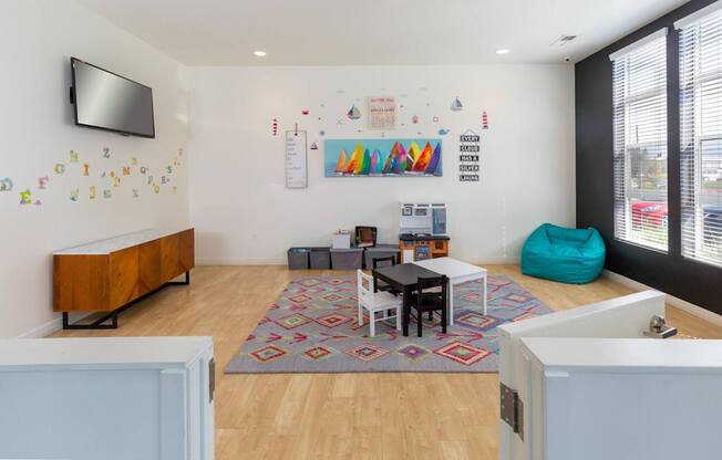 A room with a white wall and a TV on it.