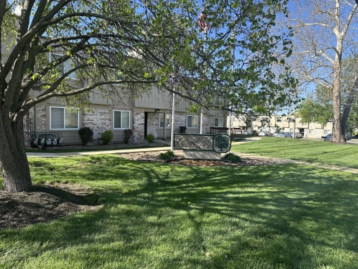 a house with a green sign in the grass