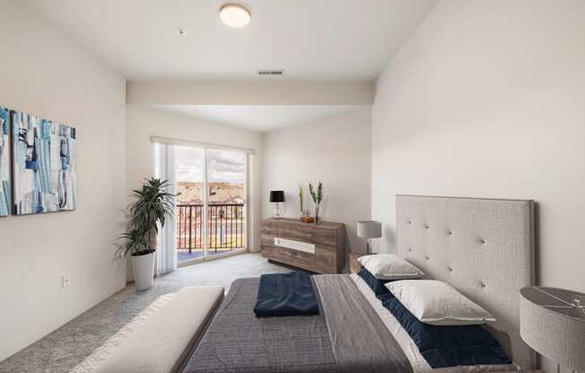 a bedroom with a queen-size bed and access to the private balcony.at Shoreline Village, Richland, WA