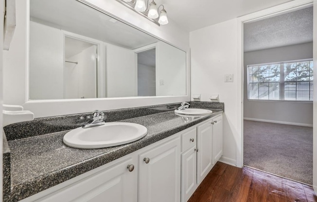 A bathroom with a sink and mirror.