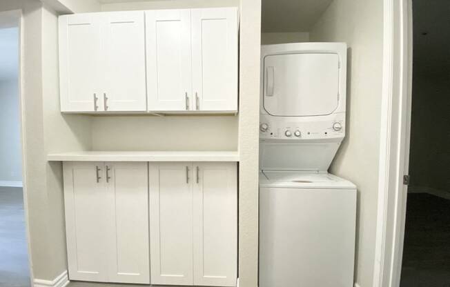 Laundry in unit with cabinets