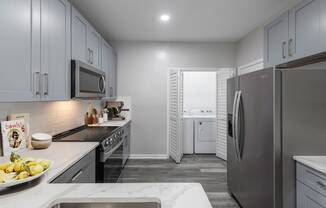 a kitchen with stainless steel appliances and white cabinets