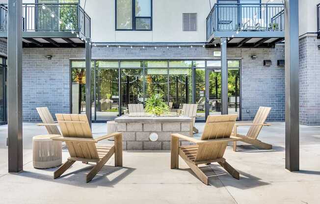Two chairs and a table are on a patio.