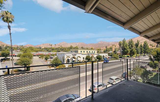 the view of the parking lot from the balcony of a building with a parking lot