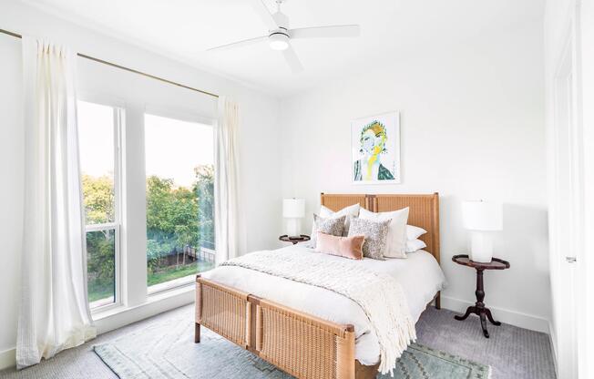 Primary bedroom with tall windows, soft finishes, and abundant natural light creating a bright, comfortable retreat in Dallas.