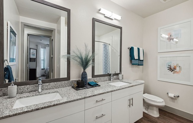 a bathroom with two sinks and a mirror and a toilet at LynnCora, Grand Prairie, TX, 75052