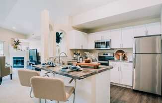 Dining area and kitchen with stainless steel appliances