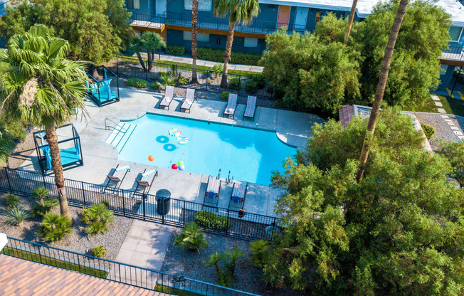 University District Apartments - Fifteen 50 Apartments - Aerial View of Sparkling Pool Surrounded By Lounge Chairs and Lush Landscaping