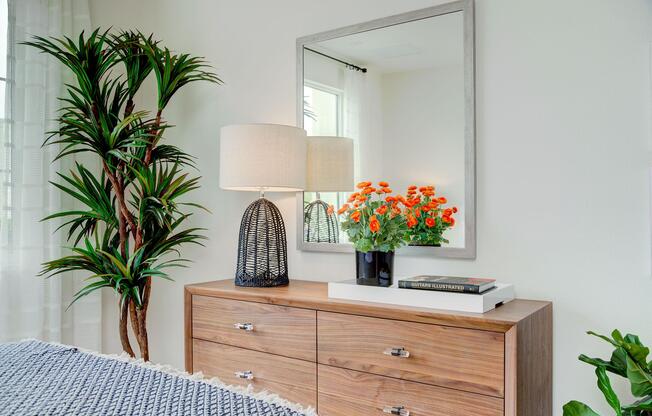 a room filled with furniture and vase of flowers on a table