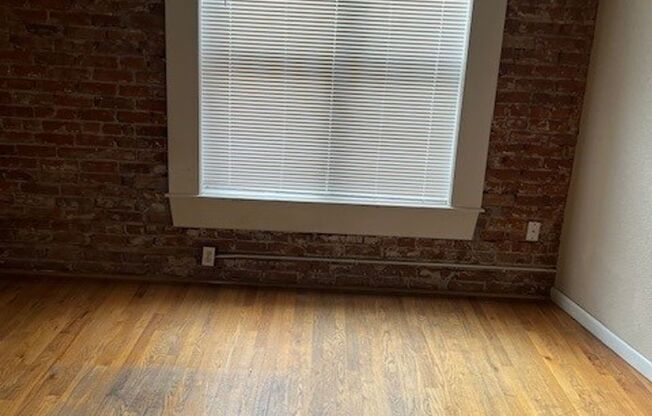 PRICED REDUCED!! Large windows and exposed brick wall