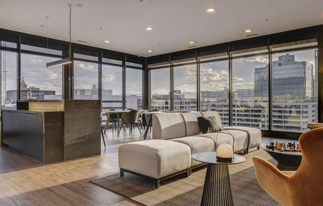 a living room with a city view and a couch and a table