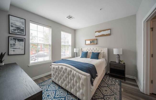a bedroom with a large bed and two windows at Harbor Pointe, Bayonne, NJ, 07002