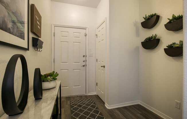 a hallway with white doors and a desk and a door to a closet