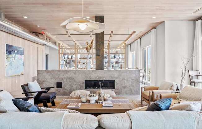 A modern living room with a fireplace and a large painting on the wall.